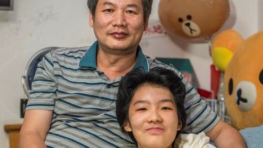 Huang Chong and her father Huang Wen Shang are pictured together as they discuss the gaming rules in China